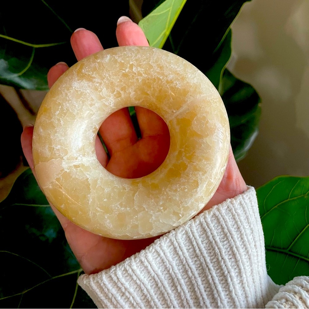 Large polished calcite donut ring.  Carved yellow calcite donut